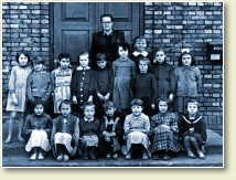 (1/5): 1961 r. - pani Aniela Kańska z klasą. Fotografia wykonana na tle szkoły.